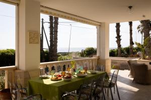 a table with a green table cloth on a patio at Maison Gioia di Casa Camilla Journey in Capilungo