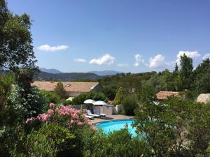 a swimming pool with a view of the mountains at chambre residence stella d'oro in Porto-Vecchio
