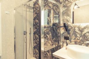 a bathroom with a shower and a sink at Palazzo Digiuseppe Rooms in Martina Franca