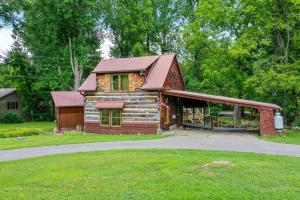 a log cabin with a red roof at Riverside in Townsend