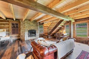 a living room with a couch and a stone fireplace at Riverside in Townsend