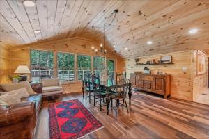 a living room with a table and a dining room at Riverside in Townsend
