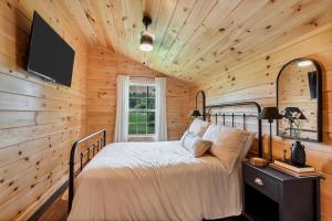 a bedroom with a bed in a wooden wall at Riverside in Townsend