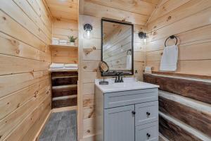 a bathroom with a sink and a mirror at Riverside in Townsend +30 photos