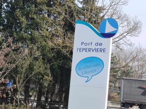 a sign in front of some trees with a truck at The Blue Boat in Valence +5 photos