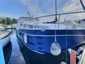 a blue boat is docked in the water at The Blue Boat in Valence
