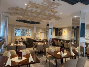 a restaurant with tables and chairs in a room at HELENA Hotel & Restaurant in Mirow +5 photos