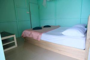 a bed with two phones sitting on top of it at Phi Phi Oceanview Hill Bungalows in Phi Phi Islands +4 photos