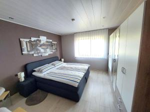 a small bedroom with a bed and a window at Schneckenhütte in Meschede