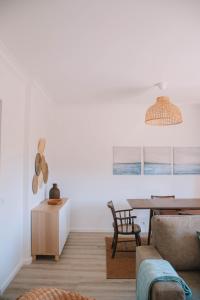 a living room with a table and a chair at Just Like Home - Retorta do Pico in Caminha