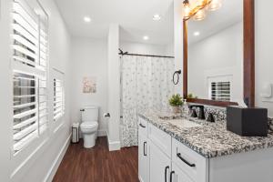 a white bathroom with a sink and a toilet at Bear Paws in Townsend +22 photos