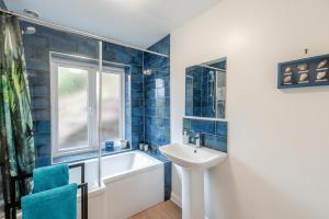 a bathroom with a tub and a sink and a window at 2 Bed in Berrynarbor oc-l34468 in Berrynarbor +17 photos