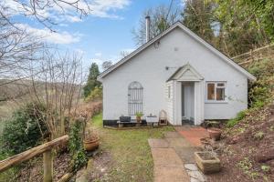 a small white house with a pathway leading to it at 2 Bed in Berrynarbor oc-l34468 in Berrynarbor