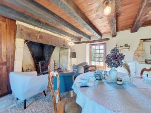 a dining room with a table and chairs at Holiday Home Le Petit Gîte by Interhome in Jayac