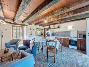 a kitchen and living room with a table and chairs at Holiday Home Le Petit Gîte by Interhome in Jayac +9 photos