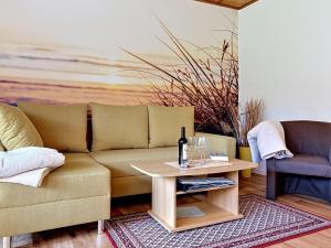 a living room with a couch and a table at Holiday Home Alexorella by Interhome in Godern