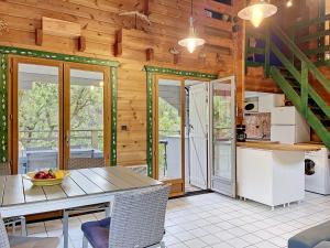 a kitchen and dining room with a table and chairs at Holiday Home L'Escouarte by Interhome in Maubuisson