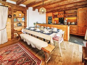 a dining room with a table and a kitchen at Chalet Saint Piran-1 by Interhome in Villars-sur-Ollon