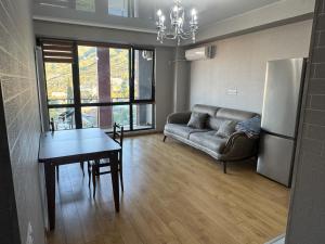 a living room with a couch and a table at monolit residens 6C blok in Tbilisi City