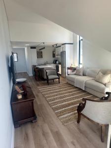 a living room with a couch and a kitchen at St Francis Links- Gallery Deck Links Villas in St Francis Bay
