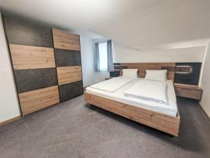 a bedroom with a large bed in a room at Apartment Haus Toferer by Interhome in Grossarl