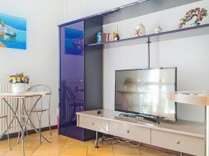 a living room with a tv on a shelf at Apartment Euroville-1 by Interhome in Germignaga