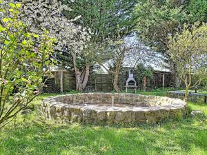 a stone fountain in the middle of a yard at Apartment Carola by Interhome in Godern