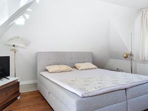 a small bedroom with a bed and a television at Holiday Home Moselhäuschen by Interhome in Traben-Trarbach