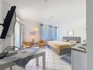 a bedroom with a bed and a desk with a television at Apartment Appartement A12 by Interhome in Traben-Trarbach