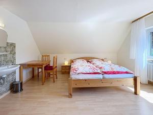 a bedroom with a bed and a desk and a table at Apartment Fischer by Interhome in Eisenbach