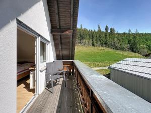 a balcony with a bed and a table and chairs at Apartment Fischer by Interhome in Eisenbach