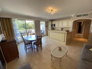 a kitchen and a living room with a table and chairs at Apartment Le Domaine de la Baie-1 by Interhome in Cavalaire-sur-Mer +23 photos