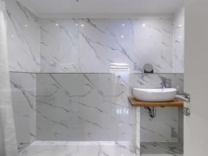 a bathroom with a sink and marble walls at Apartment File-6 by Interhome in Zambratija