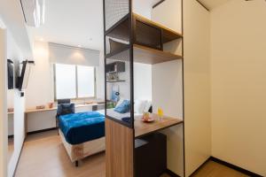a bedroom with a bunk bed and a desk in a room at Uliving Rio in Rio de Janeiro