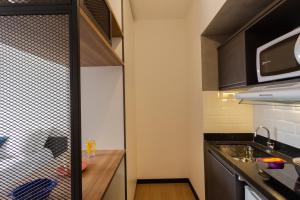 a small kitchen with a counter and a sink at Uliving Rio in Rio de Janeiro