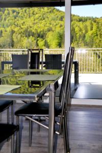 a table and chairs on a balcony with a view of a mountain at Casa Bicicletta in Fuschl am See