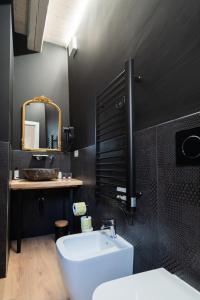 a bathroom with a white sink and a mirror at B&B Le Suite del Corso in Lugo +76 photos