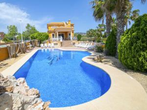 a swimming pool in front of a house at Villa Villa Delfín by Interhome in Calpe