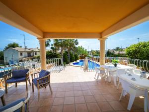 a patio with tables and chairs and a pool at Villa Villa Delfín by Interhome in Calpe +38 photos