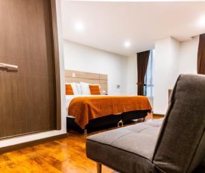 a hotel room with a bed and a couch at Hotel Plaza Carnaval in Pasto +45 photos