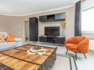 a living room with a wooden coffee table and a chair at Villa Mys by Interhome in Miami Platja