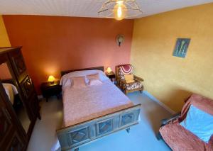 an overhead view of a bedroom with a bed and a chair at Le champ godeau in Chilly