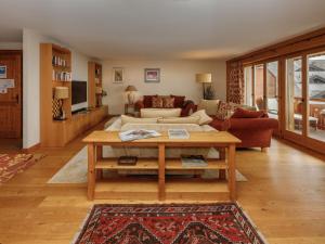 a living room with a couch and a table at Apartment Pré Vert 3 by Interhome in Villars-sur-Ollon