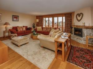 a living room with a couch and a fireplace at Apartment Pré Vert 3 by Interhome in Villars-sur-Ollon +49 photos