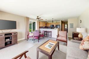a living room with a couch and a table at Ocean View Condo Pono Kai Resort PF-G102 in Kapaa