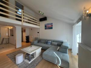 a living room with a couch and a table at Seafront Apartment Bakar in Bakar