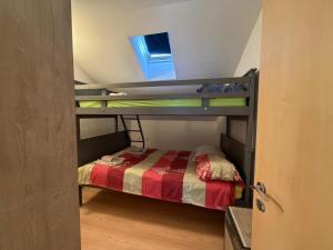 a bunk bed in a small room with a window at Seafront Apartment Bakar in Bakar