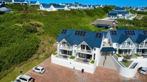 an aerial view of a house with blue roofs at St Francis Links- Gallery Deck Links Villas in St Francis Bay