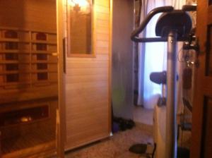 a room with a fireplace and a lamp next to a door at Stefanina Guesthouse in Bozhentsi +130 photos