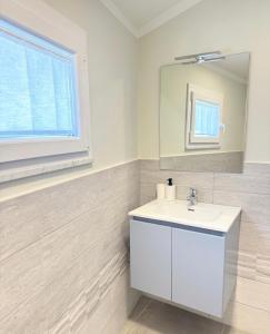 a white bathroom with a sink and a mirror at Dimora San Francesco in Sarzana +26 photos